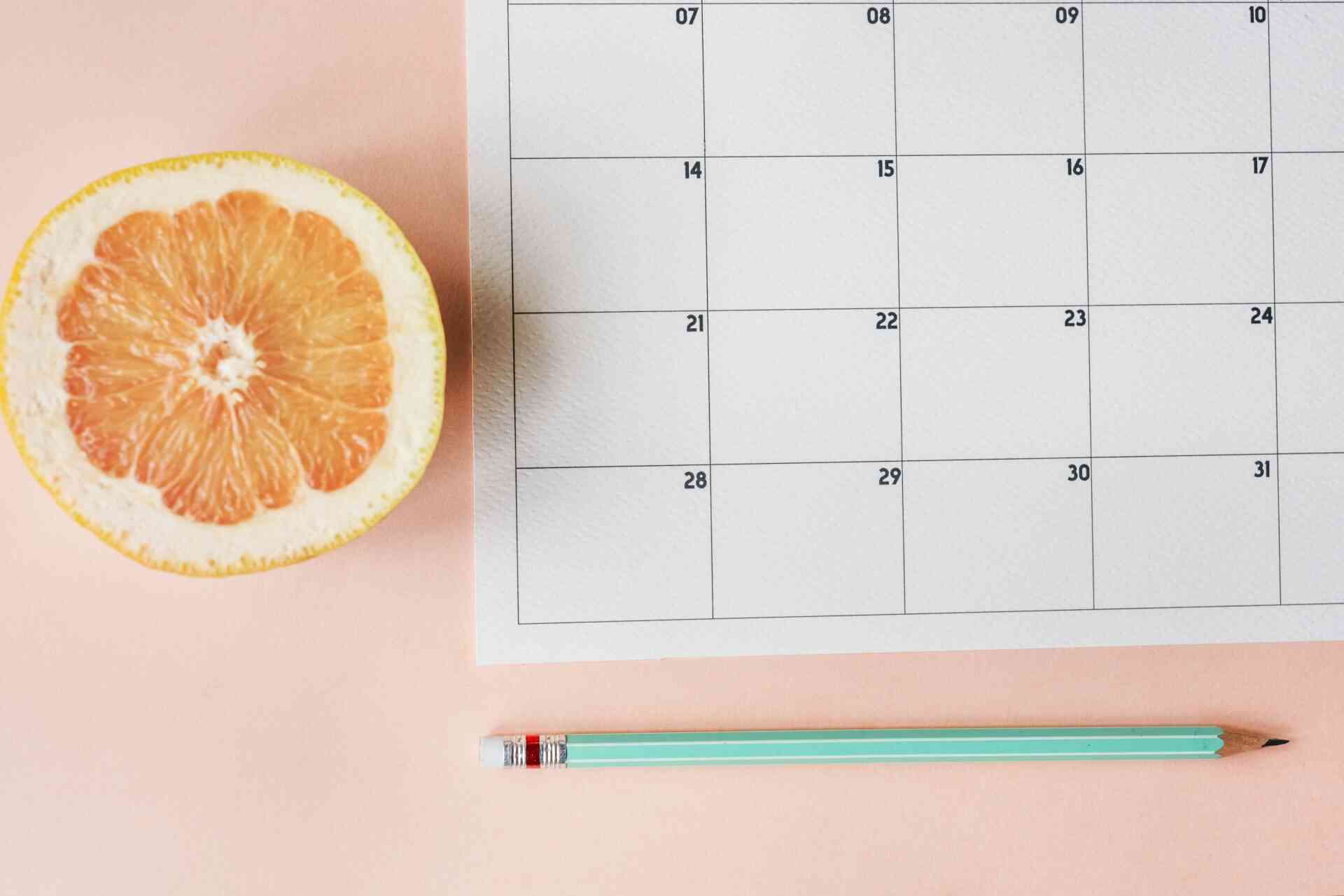 Calendário com uma fruta e um lápis ao lado